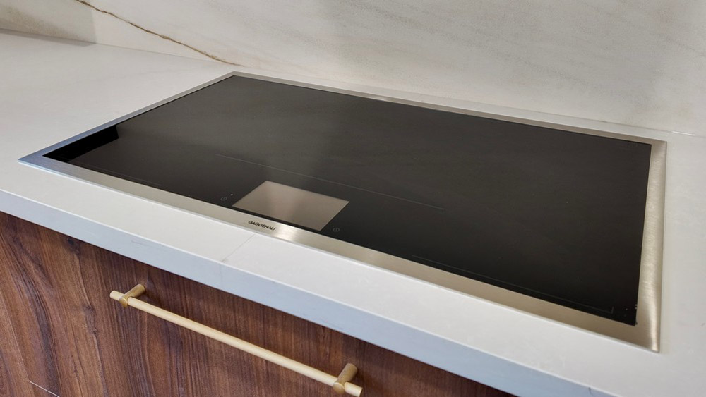 Miele wall oven and steam oven stacked in the tall cabinetry