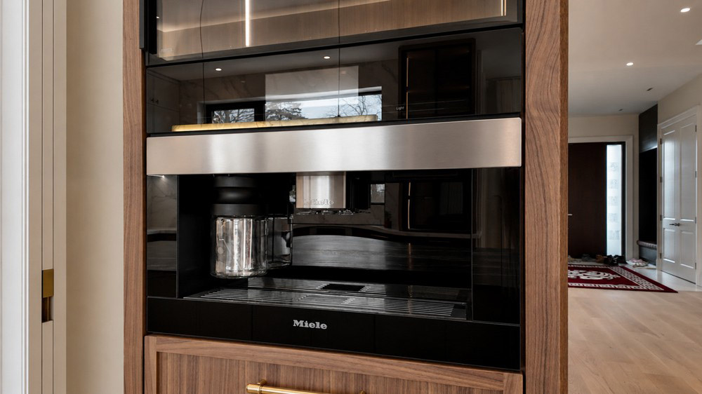 Miele built-in coffee system set into walnut cabinetry