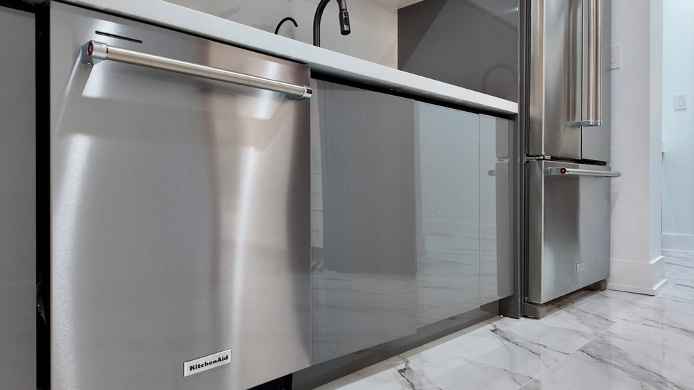 KitchenAid stainless dishwasher and freestanding French-door refrigerator