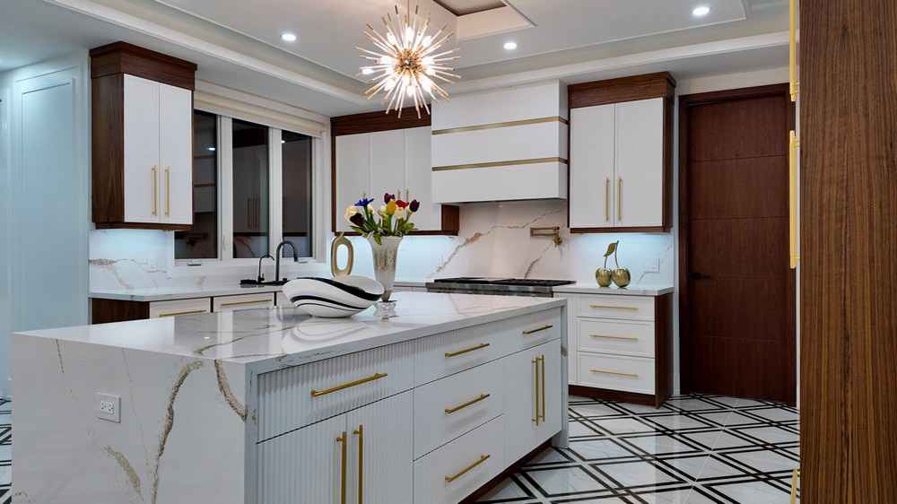 Fluted island front with brass pulls and custom white hood surround