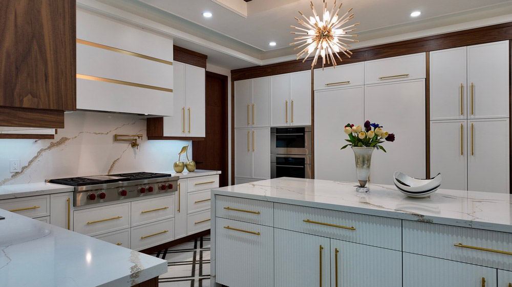 Wolf gas rangetop and integrated tall cabinetry across the main kitchen