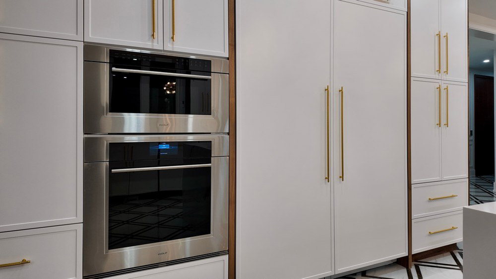 Wolf built-in wall oven and convection steam oven beside panel-ready refrigeration