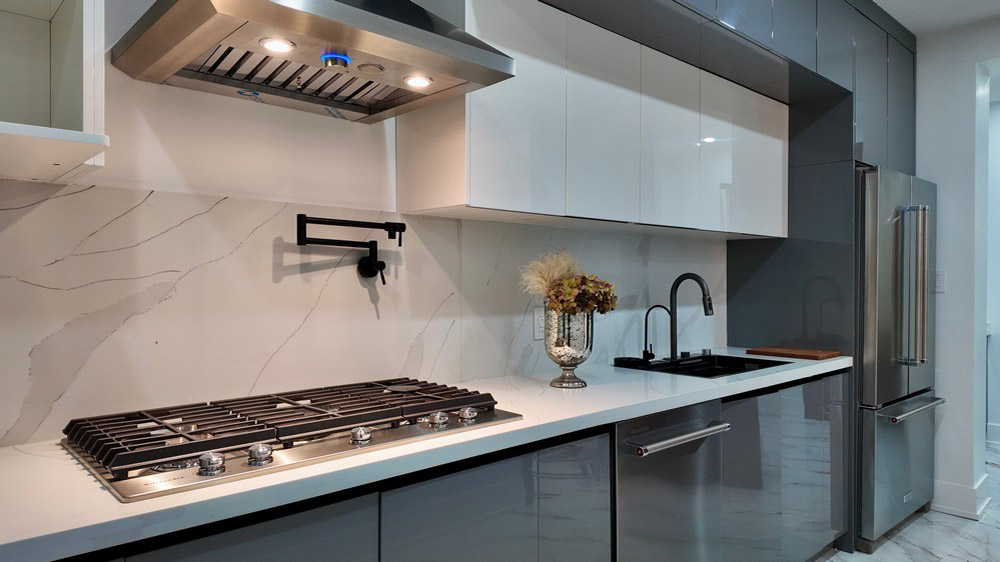 Secondary kitchen with KitchenAid gas cooktop and Elica ventilation hood