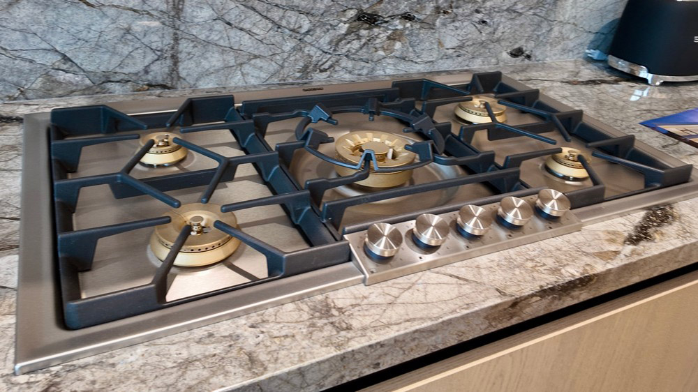 Gaggenau gas cooktop set into natural stone countertop