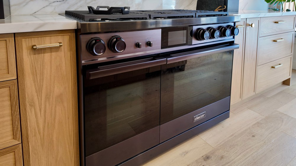 Close view of the black Dacor professional gas range and wood cabinetry