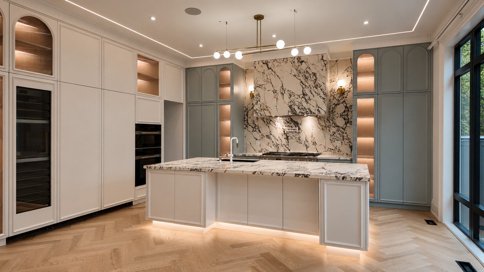 Marble-topped island with under-lit base and fluted-glass display cabinetry