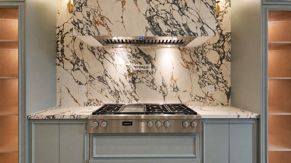 Miele 48-inch gas rangetop with griddle beneath the Elica built-in hood