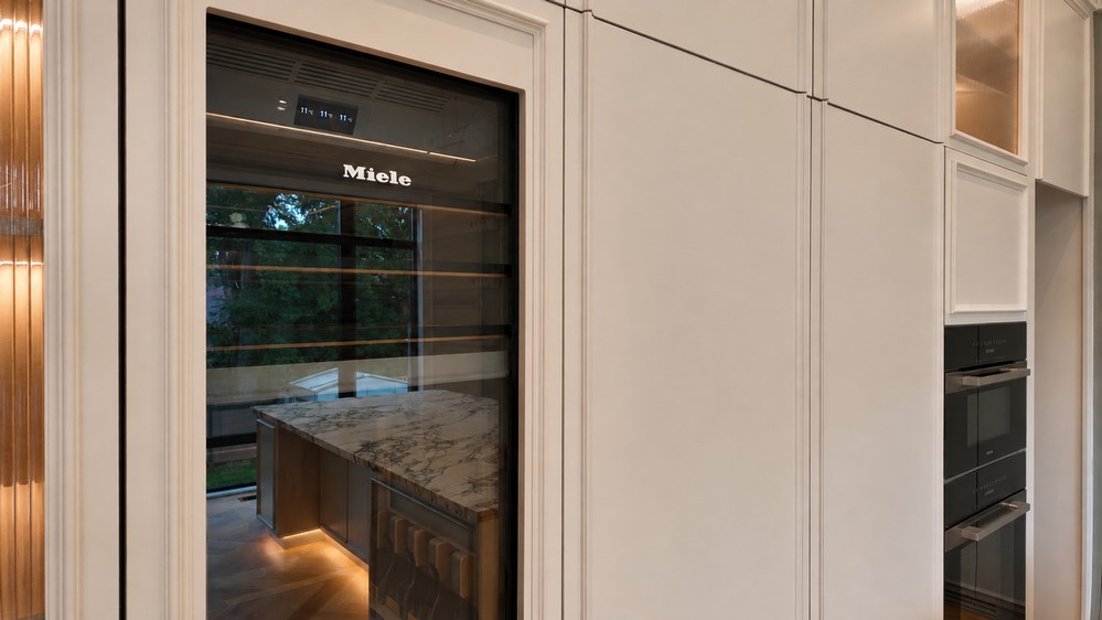 Miele MasterCool panel-ready wine storage integrated into the tall cabinetry