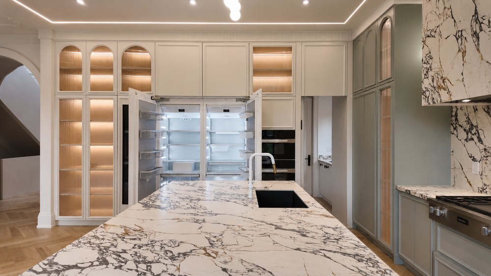 Miele MasterCool refrigeration open behind panel-ready cabinet fronts