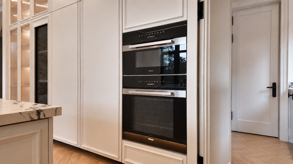 Miele PureLine speed oven and oven stacked in the warm white millwork