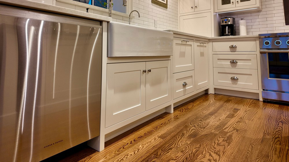 Fisher & Paykel stainless dishwasher beside the farmhouse sink