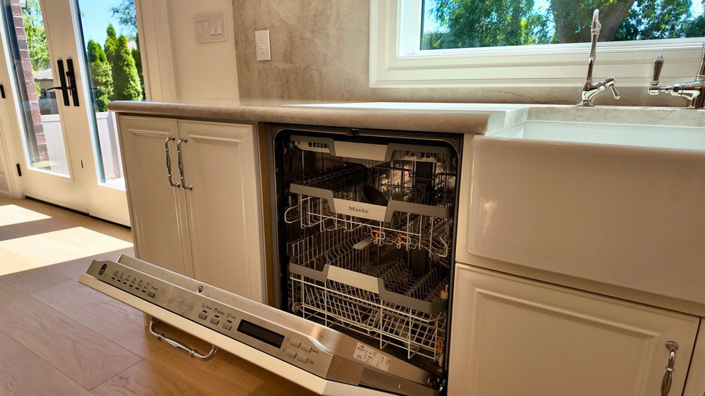Integrated dishwasher open with the terrace doors beyond