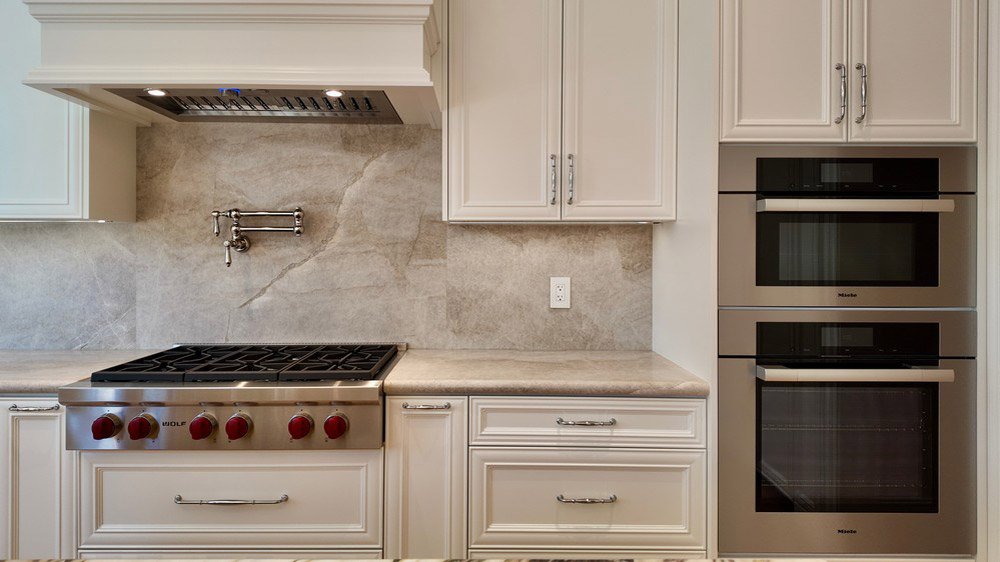 Wolf rangetop and Miele speed oven and convection oven in the tall cabinetry
