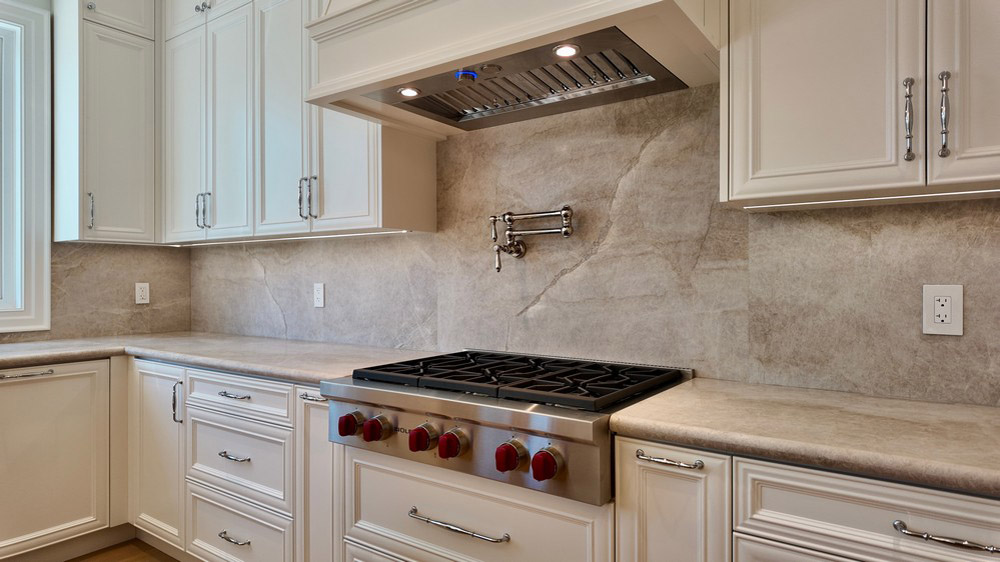 Wolf rangetop with the Elica hood insert set into the custom surround